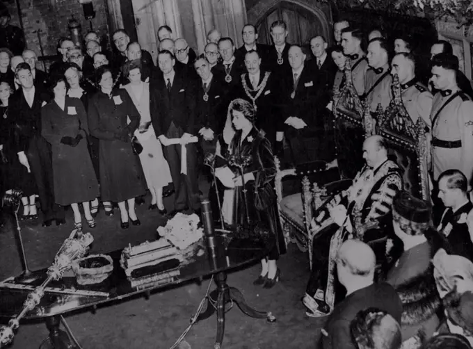 Princess Replies To Lord Mayor's Welcome - Princess Elizabeth Replies to an address of welcome by the Lord mayor of London (Seated right), During A reception and luncheon at The Guildhall today, November 19. Seated on the Extreme right is the Duke of Edinburgh. Standing behind the chairs are the five 'Mounties' who accompanied the Princess and the Duke Durin their tour across Canada. November 19, 1951. (Photo by Associated Press Photo).