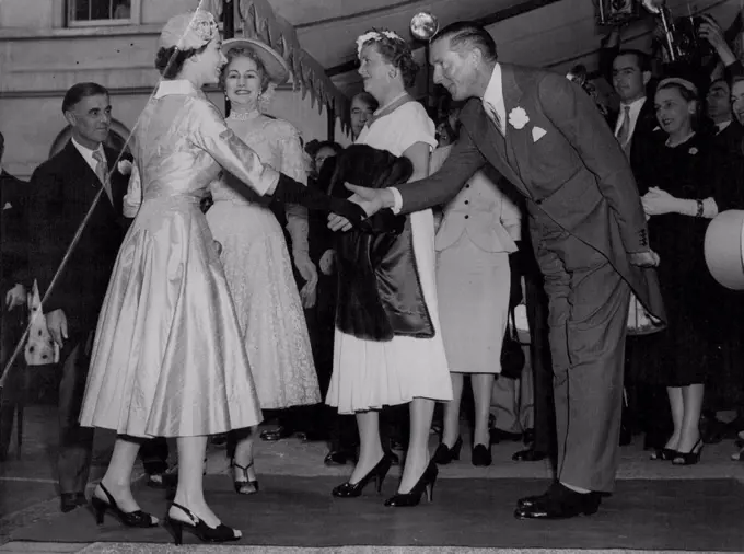 Queen Attends Friend's Wedding Reception -- The Queen is received on arrival at Hutchinson House, Stratford Palace, London, to-day (Wednesday) to attend the wedding reception of her friend, Lady Mary Baillie - Hamilton and Mr. Adrian Bailey, who were married at St. James' Spanish Place, W. Lady Mary was a maid of honour to the Queen at the Coronation. She is the daughter of the Earl and Countess of Haddington. July 21, 1954. (Photo by Reuterphoto). 