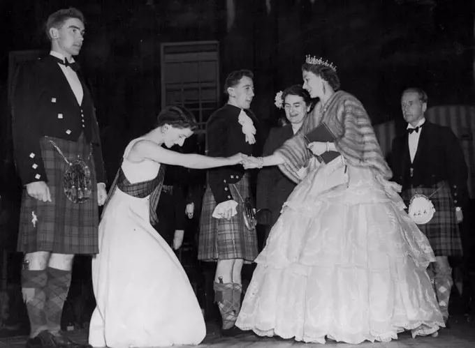 Scottish Dancers Presented To Queen -- Miss Allie Anderson presents country dancers to the Queen at the palace of Holyroodhouse during a concert held at the palace near Edinburgh on June 28. On the right is the Duke of Hamilton. Her Majesty is paying a six-day visit to Edinburgh. June 30, 1952.