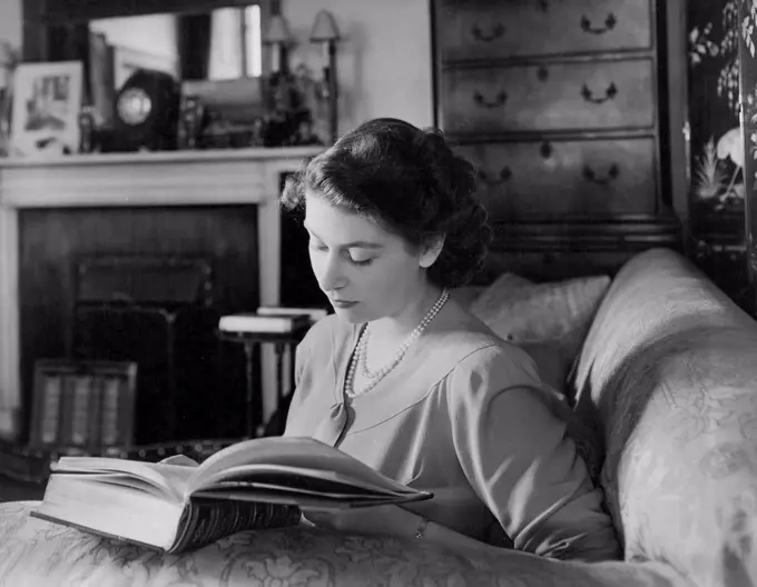 Buckingham Palace July 19th 1946. - Queen Elizabeth reading. June 16, 1953. (Photo by Camera Press Ltd.).