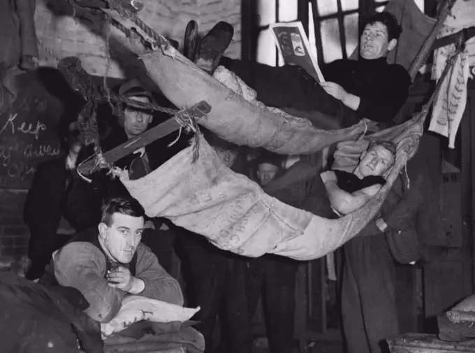 Stay-in strikers relaxing in the comfort of "home-made" hammocks at the South Melbourne gas works. August 20, 1937. 