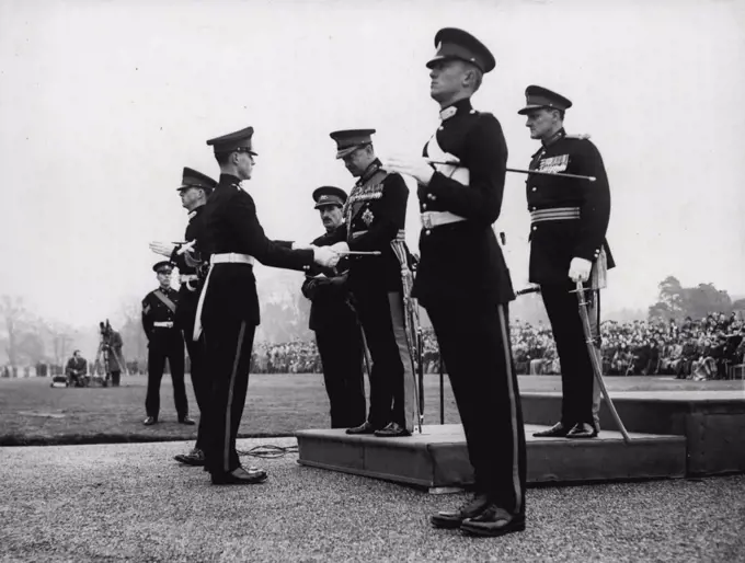 The Sovereign's Parade At Sand Hurst: Field Marshal the Earl Alexander of Tunis Presents the Sword of Honour to Senior Under Officer Lord P.T. de la P. Beresford, heir Presumptive to the Marquessate of Waterford, at the Sovereign Parade at the Royal Military Academy at Sand Hurst today. February 11, 1953.