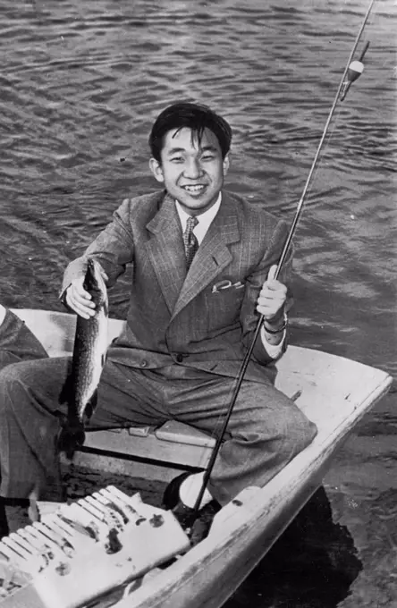 Crown Prince Lands Fish -- The Crown Prince Akihito of Japan smiles holding a 16-inch pickerel he caught while fishing on Naushon Island, off Woods Hole here today. The 19-yr-old Prince proved himself an expert fisherman during the short rowboat trip catching the pickerel, a bass, a perch and three turtles. The Crown Prince's two-day Massachusetts trip will end tomorrow after a visit to Harvard University and a sightseeing tour of Boston. September 20, 1953. (Photo by AP Wirephoto).