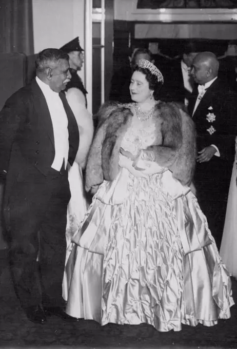 British Commonwealth History Made - H.M. The Queen with the King just behind her arriving at the reception this evening. On the left is Don Senanayake, Prime Minister of Ceylon, and on right is Sir Oliver Goonetilleke, High Commissioner for Ceylon.When The King and Queen attended a reception to-night, given by the High Commissioner for Ceylon, Sir Oliver Goonetilleke, British Commonwealth history was made for it was the first social occasion of its kind given by one of the three youngest dominions and graced by the presence of the King and Queen. October 27, 1948. 