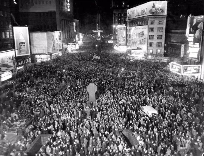 Times Square Throng Hails New Year.This Picture of Jam-Packed Times Square in New York was made exactly at Midnight Dec.31 as New Yorkers Thronged the "White Way" to welcome 1946. The view is from 47th street and Broadway, looking south. January 1, 1946. (Photo by Associated Press Photo).