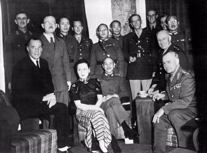 Generalissimo And Madame Chiang Kai-Shek receive General Sir Archibald Wawell and Lieut-Gen, George Brett, commander-in-chief and deputy commander-in-chief respectively, of the Allied Forces in the Southwest Pacific, on their recent visit to Chungking to confer with the Generalissimo on the Allied command, Left to right, seated, Sir Archibald Clark Kerr, Ambassador to China until January 1942, now Ambassador to U.S.S.R., Madame Chiang, Generalissimo Chiang, Lieut-Gen. Brett, General Wavell 1/2 Behind Sir Archibald Kerr is Gen. Lancelot Dennys, head of British Military Mission to China; between Sir Archibald and Madame Chiang is Ow en Lattimore personal political adviser to the Generalissimo behind Generalissimo is General Ho Ying-chin and next to him is Brig-GeneralJohn Magruder head of the American Military, Mission to China. April 10, 1951.