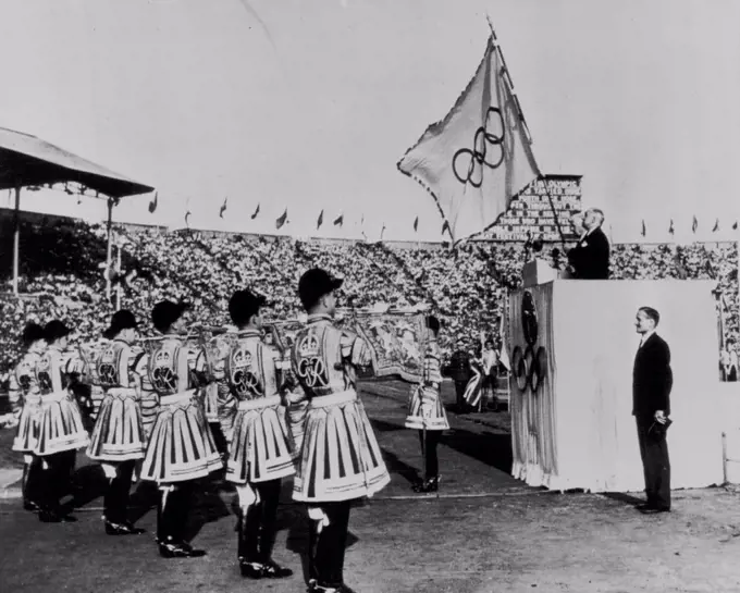 The XIV Olympiad Closed -- Sir Frederick Wells, lord mayor of London, holds the Olympic flag as the state trumpeters blare the official end of the fourteenth modern Olympic games is Wembley Stadium in London Saturday. At Well's right is J. Sigfrid Edstrom, President of the International Olympic committee. Right foreground is Lord Burghley Chairman of the Olympic organizing committee. August 16, 1948. (Photo by AP Wirephoto).