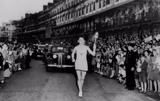 SP Olympics 1948 - London Olympic Torch -- Peet Officer Barney Barnes who had the honor of bearing the torch ashore speed along Dover front on the first stage of its journey to-night to Wimbley. Olympic Flame arrives in Britain. July 28, 1948. (Photo by Reuterphoto).