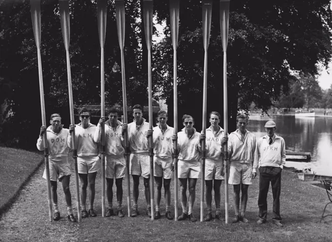 Light Blue Eight To Row Olympic Boat - The Cambridge Olympic crew photographed on the river between Marlow and Henley where they are engaged in training. They are, left to right: D.D. Macklin (bow), A.L. McLeod, N.N.B. Clack, R.F.A. Sharpley, E.J. Worlidge, C.B.M. Lloyd, W.A. Windham, D.M. Jennens (stroke), and J.F.K. Hinde (cox).The Cambridge University Leander Club eight has been chosen to represent Britain in the Olympic Regatta. The crew includes six of the successful Camoridge 1951 eight, and one of the 1950 Steering will be J.F.K. Hinde, Cambridge cox for the past two years. June 13, 1952. (Photo by Fox Photos).