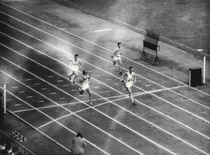 Treloar Wins 200 Metre Heat - John Treloar of Australia (No. 18) wins heat 18 of the Olympic 200 metre sprint at Helsinki's Olympic stadium yesterday, July 22.Second was L.T. Pinto of India (137) and third P. Karadi of Hungary (932). Treloar's Time was 21.5 seconds. July 23, 1952. (Photo by The Associated Press Ltd.).