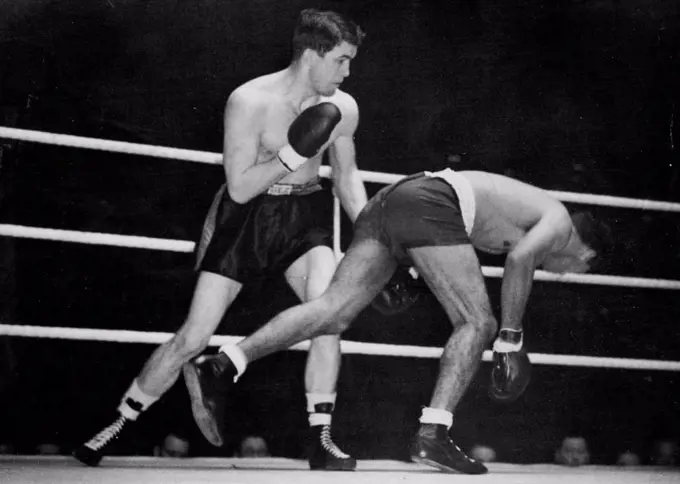 Sands Outclassed By American -- Dave Sands almost pitches through the ropes during the fight.Dave Sands, Half-Aborigine holder of the Australian triple crown in the middle, crusiser and heavyweights, was outclassed and beaten on points by American Tommy Yarsz in their ten-round fight at the Harringay Arana, North London.Before the match, Sands had been heralded as a world-beater. April 05, 1949.