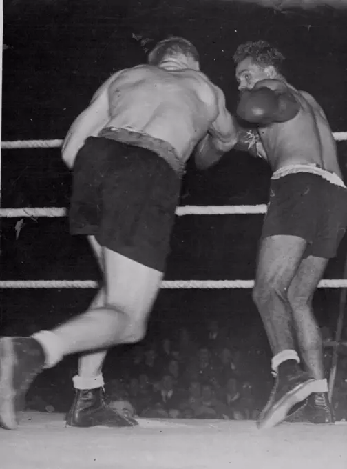 Sands V Mullett Fight At Wellington, N.Z. -- Mullett throws a solid right-hand punch, which Sands avoids by moving slightly to the left.NZ Fight. New Zealand heavyweight champion. Don Mullett, throws a solid right, which fails to connect, in his recent bout with Australian title holder Dave Sands. Sands won on points. April 10, 1948.