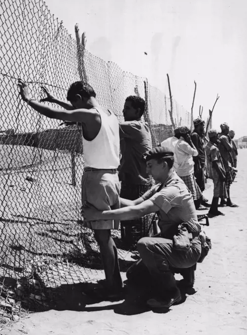 Action By Britain In Aden State Defended.A British soldier searches someone, after pistols and propaganda material were found in a big search operation, and a printing press had been seized.A British military spokesman says that four important members of the Egyptian sponsored National Front for the Liberation of Occupied South Yemen were arrested in Aden state today. Three pistols, letters and propaganda material, were discovered during a gigantic search operation. October 11, 1945.