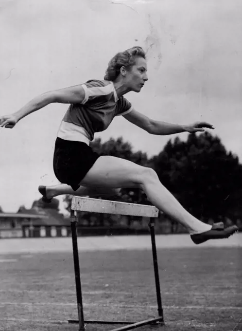 Australian Girl Hurdles To Helsinki Via London -- Miss Shirley Strickland (Western Australia), one of Australia's women athletes for the Olympic Games, practising over the hurdles at Paddington Track, London, today (Thursday).The Australian athletes are in London on their way to Helsinki. Miss Strickland is a 100 and 200-metres sprinter as well as a hurdler. June 19, 1952. (Photo by Reuterphoto).