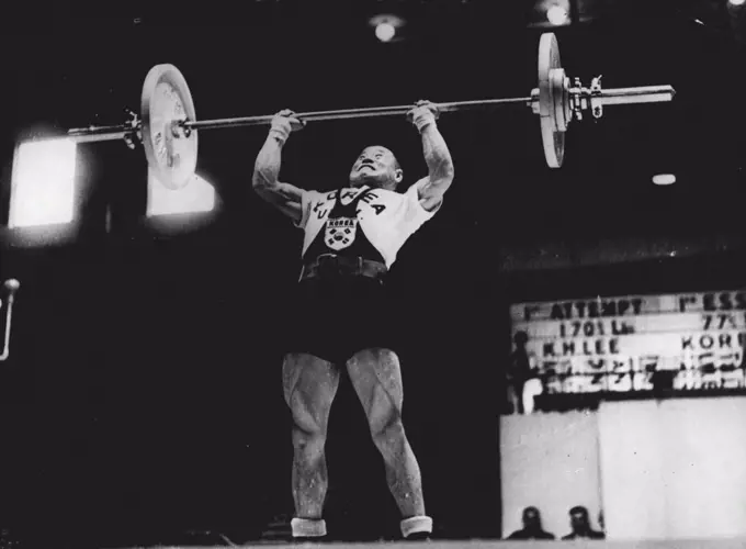 Burly Bantam: Korea's K. H. Lee takes the strain as he competes in the Bantam weight division of the Olympic games Weight-lifting contest at Empress Hall, Earls Court, London, today August 9. August 9, 1948. (Photo by Associated Press Photo).