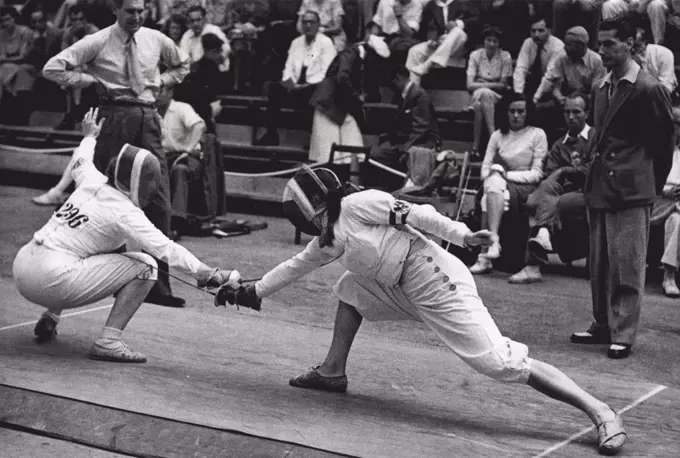 Olympic Games 1948 - Fencing - Miss M. A. Glen Haig of Gt. Britain (296) in her bout during the Women's Foils with Miss F. Filz of Austria (right), whom she defeated. August 02, 1948.