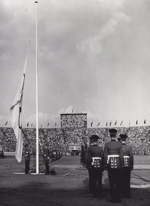 Closing of the Games of the XIVth Olympiad : The Olympic Flame is Extinguished (Centre Background) as members of the Scots guards lower the Olympic Flag during the closing of the games of the XIV Olympiad at Wembley Stadium London, Evening Aug. 14. On the Notice-Board (Background) is the message "The Spirit of the Olympic Games which has tarried here awhile sets forth once more. May it prosper throughout the world safe in the keeping of all those who have felt its noble impulse in this great festival of sport". The Olympiad flag will remain in the safe keeping of the Lord Mayor of London, until the games of the XV Olympiad are celebrated in Helsinki. August 29, 1948. (Photo by Olympic Photo Association).