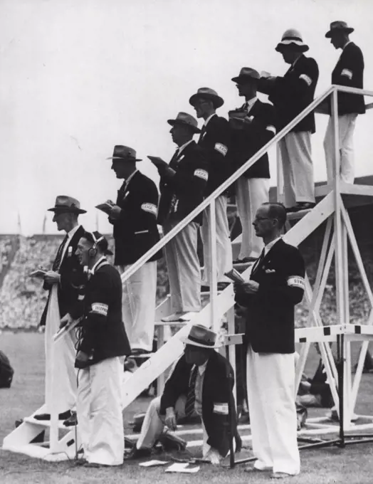 Olympic Games : Judges at the Olympic Games Women's discus throwing contest at Wembley Stadium today (Fri.) They are wearing grey soft hats, blue blazers and white flannel trousers. July 30, 1948. (Photo by Reuterphoto).