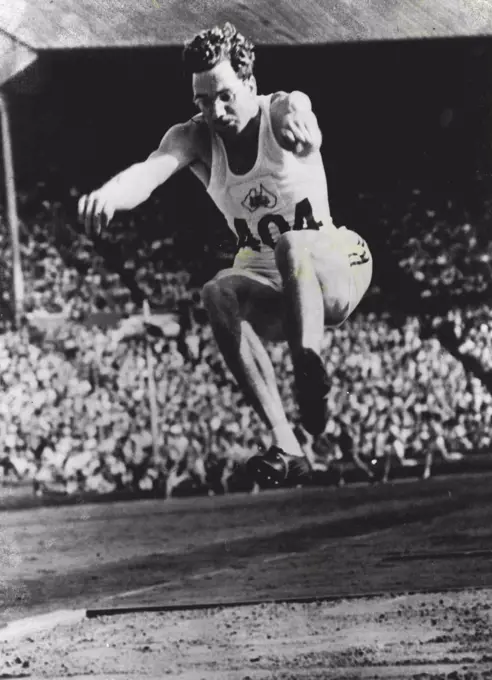 Australian In Olympic Final : Australia's T. Bruce (404) competing in the final of the Long Jump at the Wembley Stadium. July 31, 1948. (Photo by OPA Photo).