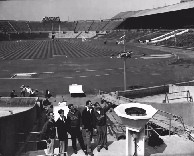 Americans View Wembley Stadium: London's Wembley Stadium, venue for the Olympic Games, looks in first-class order today, July 27, two days before the opening of the Great meeting. Today Athletes were allowed to inspect the stadium for the first time, and here, looking at the platform from which the Olympic fire will flame throughout the games, are left to right, Malvin C. Whitfield (400 and 800 metres), from Bay City, Texas, A. Richmond Morcum (Pole Vault), from Portsmouth, New Hampshire, Vern V. Mcgrew (high Jump), from Houston, Texas, and Leroy Braxton Cochran (400 metres hurdles), from Long Beach California. July 27, 1948. (Photo by Associated Press Photo).