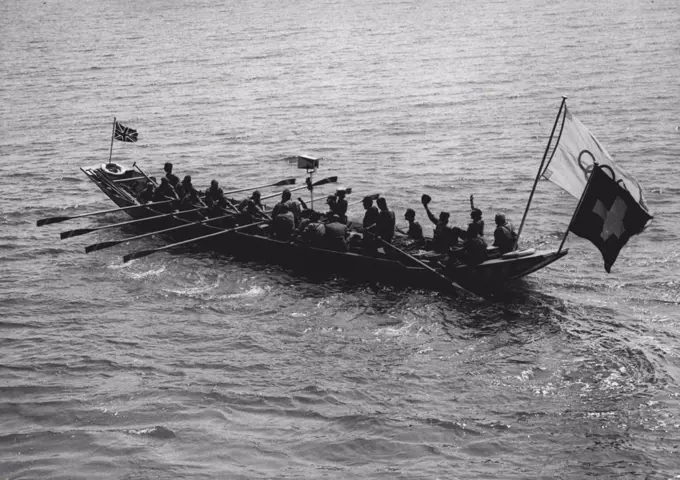 Welcome To The Games: Trippers at Southend, Essex, had a surprise when twenty-five Swiss arrived at Southend Pier in a barge. They had chosen this unique way of travelling to arrive for the Olympic Games.Alderman S. F. Johnson, Mayor of Southend and councillors greeted the Swiss, and to brighten up the occasion two bathing girls were invited to help. They were 16-year-old Patricia Harding, of Finchley London, and 16-year-old Kathleen Papworth, of Finchley... and there were some enthusiastic kisses all round.The boat of Swiss arriving at Southern for the Olympic games, reaches the pier. July 29, 1948.