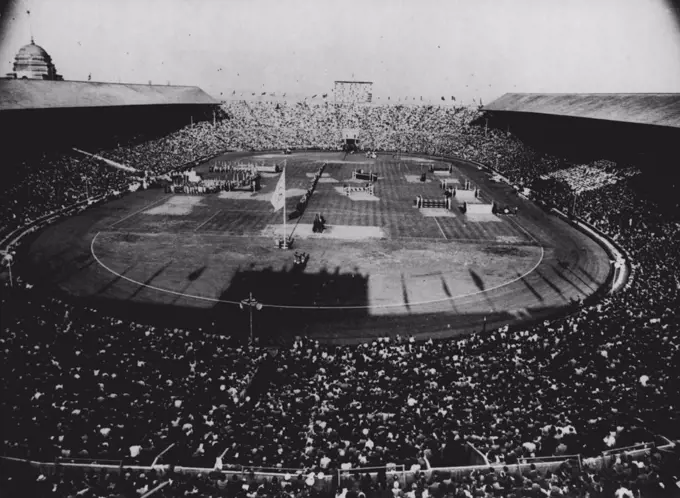 Closing Of The Games Of The XIV Olympiad : A General view inside Wembley Stadium, Aug. 14, showing crowd at the handing over of the Olympic flag to the Lord mayor of London who will retain the flag till the XV Olympiad is celebrated in Helsinki. In this picture the Olympic flag is flying at centre, the flame is seen at background whilst on tribune of honour at left stand J. Sigfrid Edstrom, President of the International Olympic Committee and Sir Frederick Wells, Lord Mayor of London. August 14, 1948. (Photo by Rota Picture)