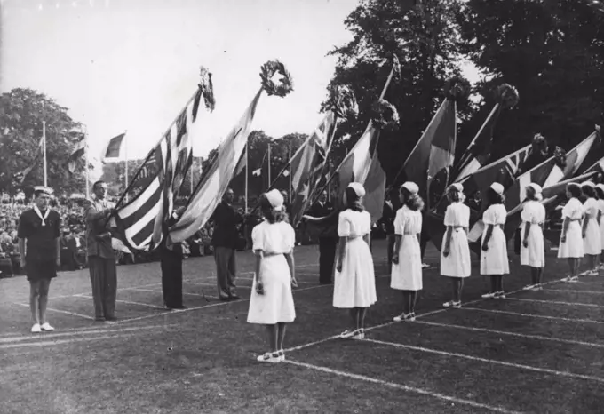 Olympic Games: Yachting at Torquay - Girls in white place laurel wreaths on the competitors flags.Closing ceremony at Torre Abbey and distribution of awards to competitors by Major Sir Ralph Gore, Bt. August 13, 1948. (Photo by Reuterphoto).