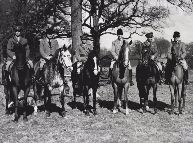 Britain's Jumpers Prepare For Olympics : A group of the riders at Aldershot today. Left to right they Major T. Palandri; Brigadier Lyndon Bolton (on "Sylveste"); Captain Rich on "Cark Royal Daniel"; Mr. E. Holland-Martin on "Shranmore"; Major D. N. Stewart on "Gold Pot", and Major P. M. Borwick, M. C., on "Dark Seal".Fourteen of the finest riders in the country, with one of the best teams of horses we have ever had, are now in training at Aldershot for the Olympic Games and for the International Horse Show at the White City immediately afterwards. April 09, 1948. (Photo by Fox).