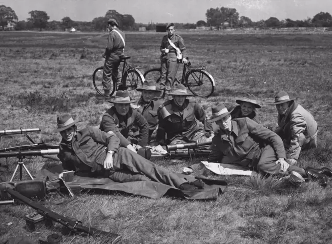 Bisley Meeting Opens : The Australian team at rest during shoots. L. to R. R. Parker (Queensland); P. Pavey (Victoria); W. J. Harris (Victoria); H. S. Holt (N.S.W.); R. B. Gratte (W. Aus); Mil Menghini (W. Aus); and N. Goff (Victoria).The National Rifle Association meeting opened at Bisley, yesterday (Monday). A team from Australia was among the competitors. July 06, 1948. (Photo by L.N.A.).