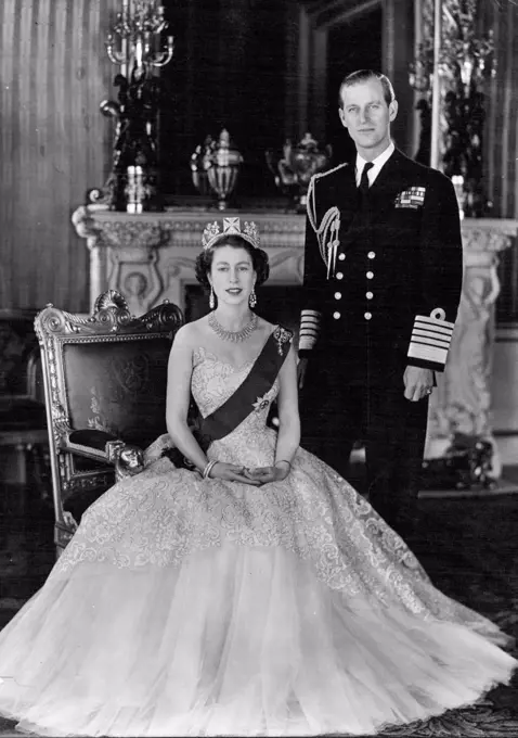 H. M. Queen Elizabeth II And H.R.H. The Duke of Edinburgh - A new portrait of Her Majesty Queen Elizabeth II and her husband, His Royal Highness the Duke of Edinburgh taken in the Green Drawing Room of Buckingham Palace. Her Majesty the Queen is wearing a pale pink evening gown of needlework lace over tulle, with the blue Ribbon and Star of the Garter, and with it a Russian fringe design diamond necklace (a wedding present from the City of London), diamond drop earrings and two diamond bangles. The diamond drop brooch at the top of the blue Ribbon is a family heirloom and has been worn by the late Queen Mary. April 26, 1953. (Photo by Camera Press Ltd.).