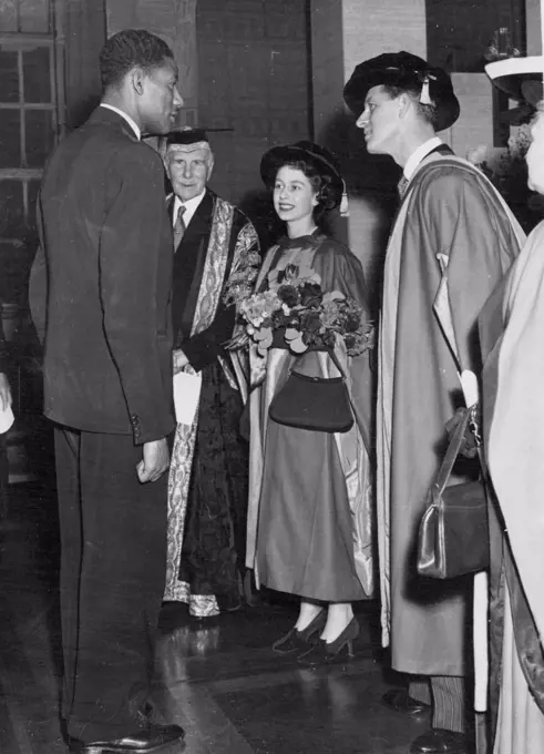 London University Honours Princess And Duke -- Arthur Wint, winner of the 1948 Olympic Games 440-yards event, is presented to Princess Elizabeth and the Duke of Edinburgh after the royal couple had received honorary degree of Doctor of Law at London University. The Presentations were made by the Earl of Athlone, chancellor of the University (in background). December 11, 1951.