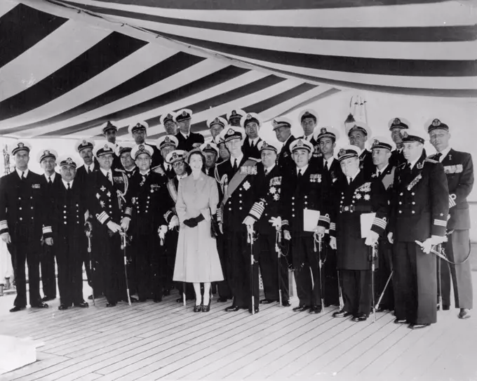 The Queen Receives Naval Officers Aboard The Royal Yacht -- H.M. The Queen and H. R. H. the Duke of Edinburgh with foreign Naval Officers aboard H.M.S. surprise this afternoon. Aboard the Royal Yacht (H.M.S. Surprise) today, H.M. The Queen received Senior officers of the Royal Navy, Flag and Commanding Officers of dominion Navies, Officers Commanding ships of foreign Navies and Officers of British Merchant Ships and Trawlers, taking part in the Coronation Naval Review at Spithead. June 15, 1953. (Photo by Fox Photos).