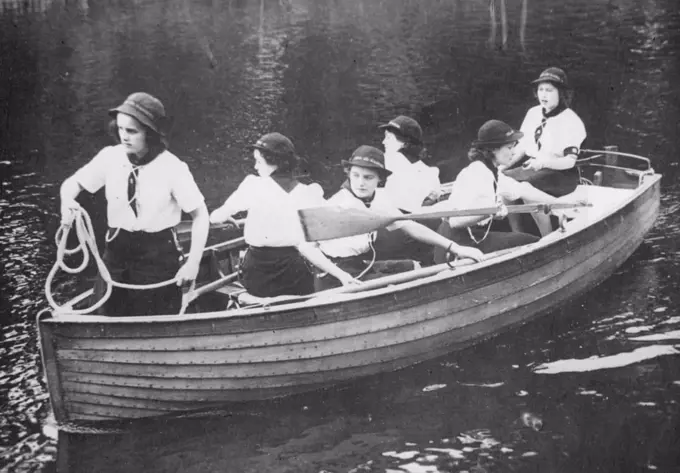 Princess With Girl Guides : Sea Ranger Princess Elizabeth takes the tiller during boating exercise. Princess Elizabeth and her sister Princess Margaret Rose visited a Girl Guides Camp. July 25, 1944.