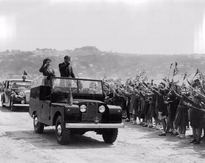 Queen Elizabeth and Duke of Edinburgh waving to children in Forbury Park, Dunedin, NZ. February 04, 1954.