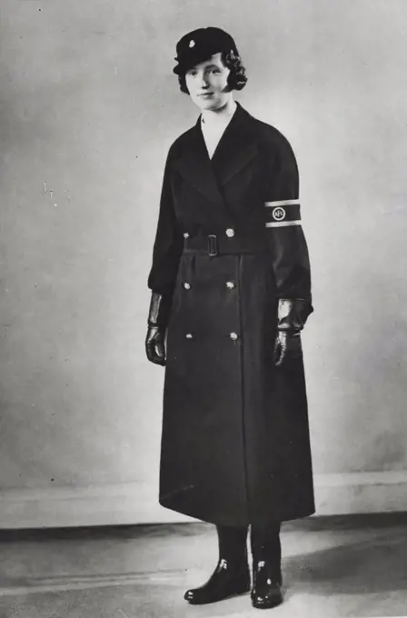 New A.R.P. Uniforms - One of the uniforms for women auxiliary motor drivers consisting of a blue gabardine waterproof coat. A.F.S. Buttons, armlet, peaked cap and rubber boots. August 2, 1938. (Photo by London News Agency Photos Ltd.)