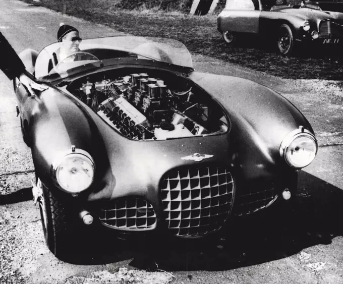 'Test-Bed on Wheels' is to Race - The massive engine which lies under the bonnet is shown in this picture of the David Brown Lagonda - an entirely new competition car - taken at a secret test circuit when it made its first run.At the wheel is Mr. David Brown, who carried out the first series of test runs.The car, which has a 4½ litre V12 engine, is described as an experimental test-bed on wheels'. It is being entered for international events because racing provides the most arduous test.The David Brown Lagonda will make its first appearance at the Silverstone circuit on May 15. Reginald Parnell will drive one in the International Sports Car Race. April 21, 1954. (Photo by Reuterphoto).