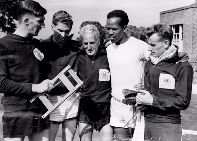 Australian Olympic Stars Train in London -- MacDonald Bailey the famous sprinter, who is training for Helsinki at Motspur Park, has a chat with members of the Australian Olympic Team who have arrived in London, and who are preparing for the Olympics at Motspur Park. They are John Treloar, hurdler Ken Doubleday, coach P. Cerutty, and walker Don Keane. June 20, 1952.