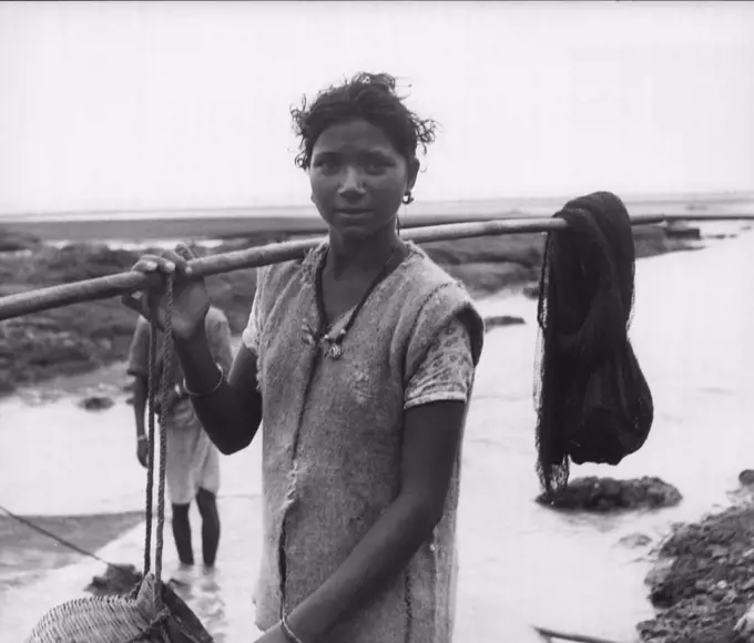 Daman -- Many Damanites, like this woman, fish for a living. Virtually blockaded, Daman still has enough food. Heavy rains have made vegetables plentiful. September 24, 1954. (Photo by United Press).