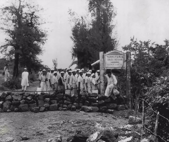 Liberation Army, Crosses Goan Border -- Anthony Desouse, 25-year-old former Bombay clerk turned agitator, climbs over stone barrier marking the India-Goa border as he leads a group of supporters into Portuguese territory on India's Independence Day last Sunday. The group, supporting the Indian campaign to merge the Portuguese enclaves in India into Indian territory, was arrested after marching several miles past the frontier. August 21, 1954. (Photo by AP Wirephoto).