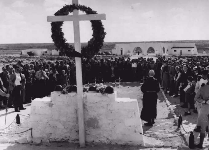 German-Italian Remembrance Day In Alamein -- A German priest officiating at the German-Italian cemetery at Tel-el-Eyssa, in Alamein, on the German Remembrance Day.Members of the German colony in Egypt stand around him as they take part in the service. November 19, 1952. 