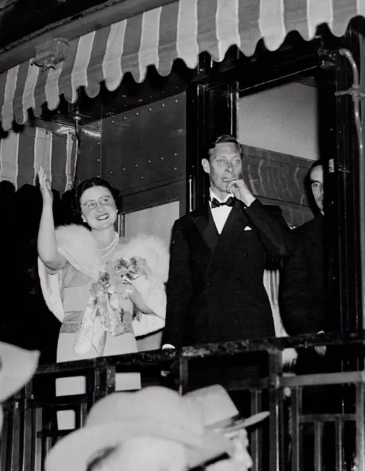 Farewell to the United States -- King George and Queen Elizabeth as they stood on the rear platform of the Royal Train and waved goodbye to President and Mrs. Roosevelt on the night of June 11th as they departed from the United States after their four day visit. June 11, 1939. (Photo by ACME).