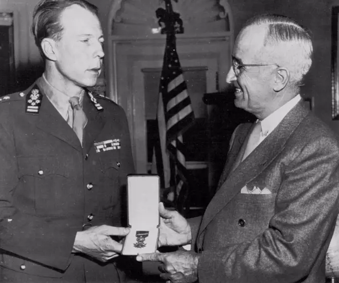 Prince Presents Medal - Prince Charles (left) of Belgium today presents to President Truman a Belgian Croix De Guerre for the U.S. unknown Soldier of World War two. The award was made with the stipulation that the honor be paid to the unknown U.S. service man whose body is brought back from a foreign Battlefield and enshrined in this Country. The presentation was made in the President's office at the White House. April 7, 1948. (Photo by AP Wirephoto).