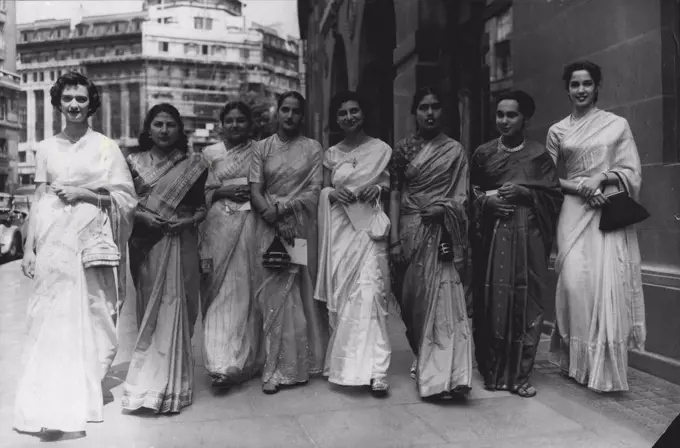 Just The Weather For Their Garden Party At The Palace -- London's sweltering weather, near to that of their own country, was all these debutantes from India needed to make their day just perfect. Leaving India House on their way to a presentation garden party at Buckingham Palace this afternoon are, left to right: the Misses Kothari, Zachariah, Talukdar, Mayor, Mugaseth, Sundaram, Thapar and Gideon. July 14, 1955. (Photo by Reuterphoto).