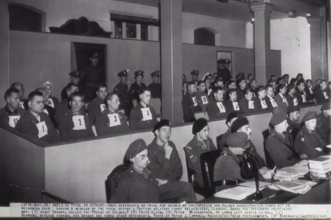 Nazis on Trial in Germany -- Nazi defendants on trial for crimes at the Oswiecin and Belsen concentration camps sit in prisoners dock during a session of the trial before a British Military court in Lueneberg, Germany. Among the prisoners identified are; (1) Josef Kramer, called the "Beast of Belsen," (2) Fritz Klein, (3) Peter Weingartner. At lower left center is Maj. T.C. Winwood, defense counsel for Kramer and three other defendants. September 24, 1945. (Photo by Peter J. Carroll, AP Wirephoto).