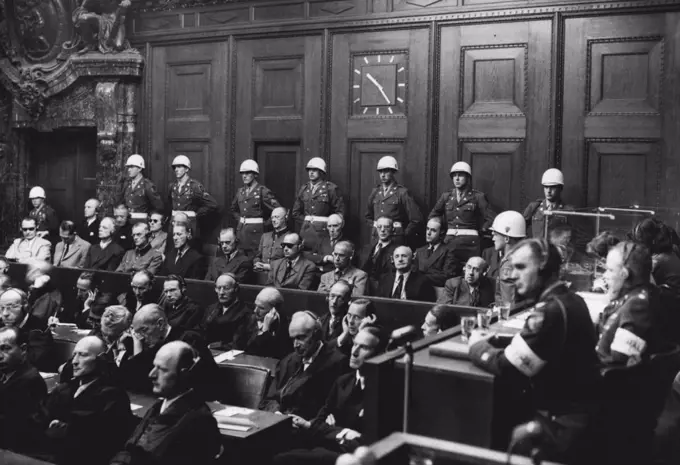 This was the scene on the day of Reckoning -- This historic judgement of Nuremberg, delivered yesterday by British, French, American and Russian judges, decided "that certain of the defendants planned and waged aggressive war against is nations and were therefore ***** of this series of crimes".Nazi Germany's 21 former leaders will hear their individual guilt and the sentences to be awarded today.With their counsel in front and united states guards at the back, the accused listen to be justice Lawrence at Nuremberg. October 1, 1946.