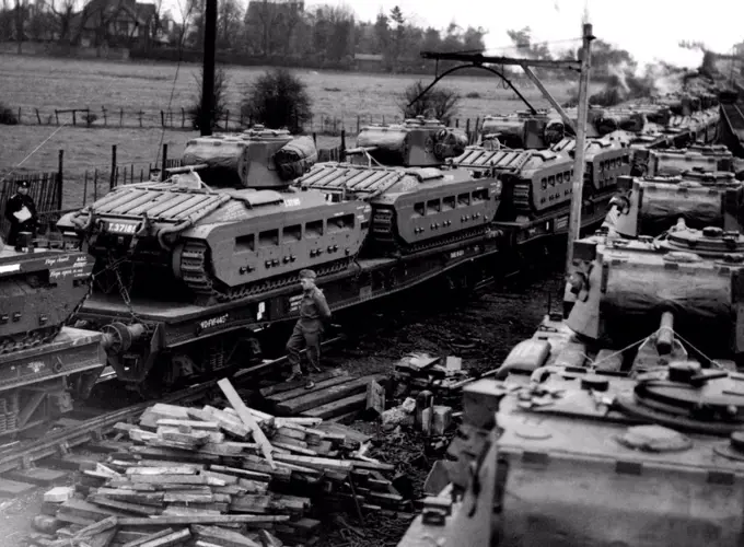 En Route To Meet Hitler's Spring Offensive -- 600 tons of tanks move off for their port of embarkation; they travel past another section of train before being leaded for departure on the next day. Vast supplies of armaments are still pouring out of our factories, for Russia and, thanks to the convey system,are reaching their destination. These tanks are leaving a large ordnance Depot somewhere in Russia". April 9, 1942. (Photo by Fox Photos).