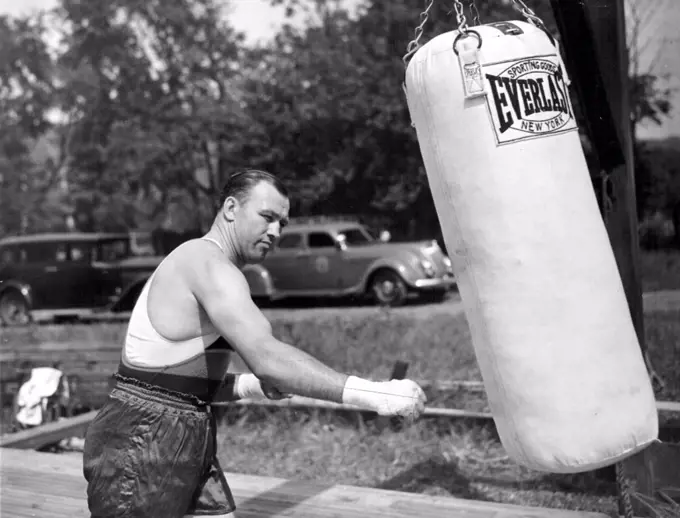 Sharkey Punches The BagJack Sharkey shown punching the heavy sand bag at his training camp here today as he began his workouts preparatory to his heavyweight fight with Joe Louis. February 17, 1953. (Photo by Associated Press Photo).