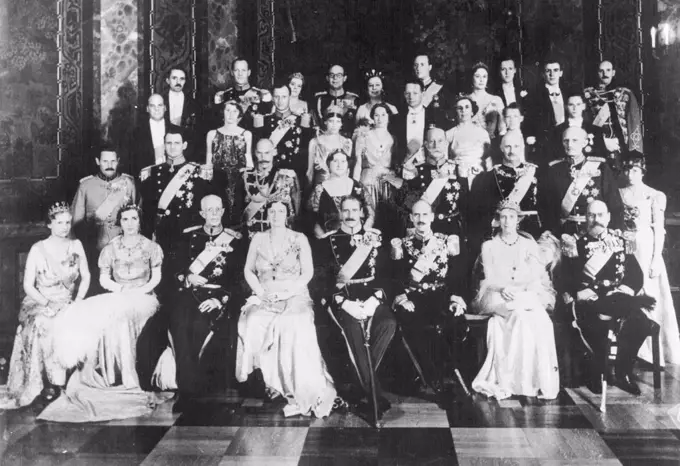 Photo Shows:- The official picture of the three Royal Families taken at Christiansborgs  Castle, Denmark, after the gala dinner in celebration of the jubilee. In the front row (starting second from left) are - left to right - Crown Princess Ingrid of Denmark; King Gustav of Sweden; Queen Alexandrine of Denmark; King Christian of Denmark; King Haakon of Norway; and Princess Ingeborg of Sweden.Three Royal Families at Jubilee Of Danish King.The three Scandinavian Monarchs - King Christian (Denmark), King Gustav (Sweden), and King Haakon (Norway) - gathered together with members of their families in Copenhagen for the jubilee Celebrations of king Christian.  May 18, 1937. (Photo by Planet News Ltd).