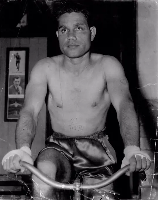 Australian lightweight champion Jack Hassen in training this week for his fight against welter champion Mick Tollis at the Stadium on Monday night.He was an expressionless boxer, not winning when a blow got through and not saying anything as he sat upright in his corner between rounds. March 17, 1951. (Photo by Sporting Life).