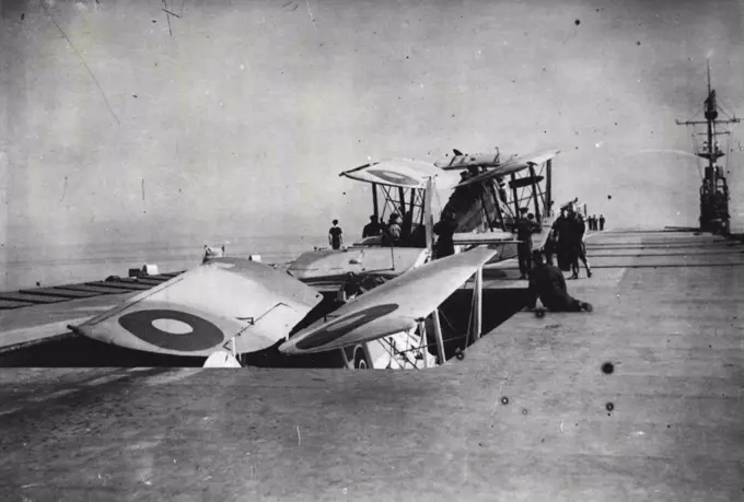 Navy's Pocket Carrier Beats U-Boat Packs - A Swordfish going down the lift of one of Britain's latest escort carriers. A second aircraft in charge of its crew is waiting. Note the extreme narrowness of the bridge, from which the ship is controlled on the right-hand side of the deck.Aboard one of the Navy's latest "pocket" escort carriers, which are proving such an effective counter weapon to the U-Boat pack. October 25, 1943. (Photo by British Official Photograph).